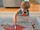 child painting as an indoor activity for kids