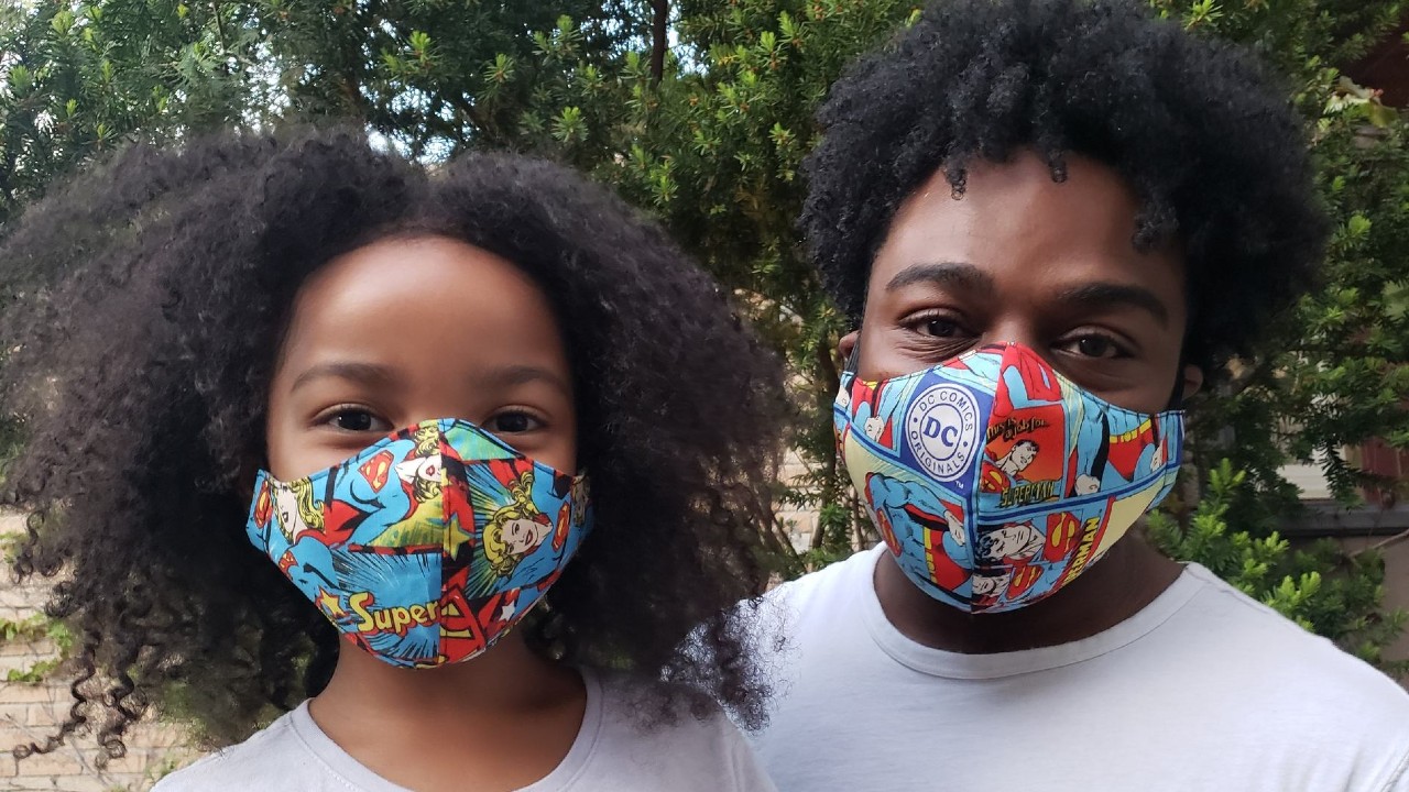 father and daughter wearing matching masks