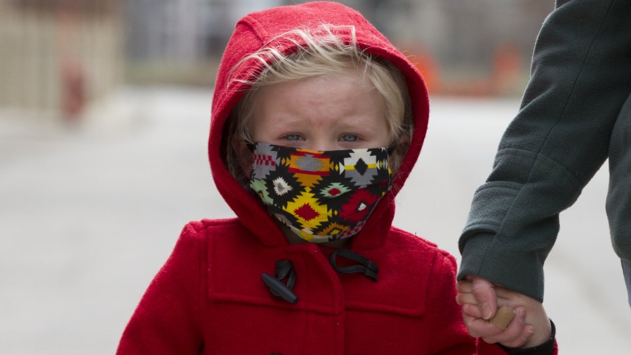 young girl wearing face mask in winter