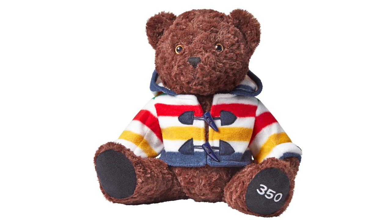 brown teddy bear wearing iconic HBC Stripes sweater