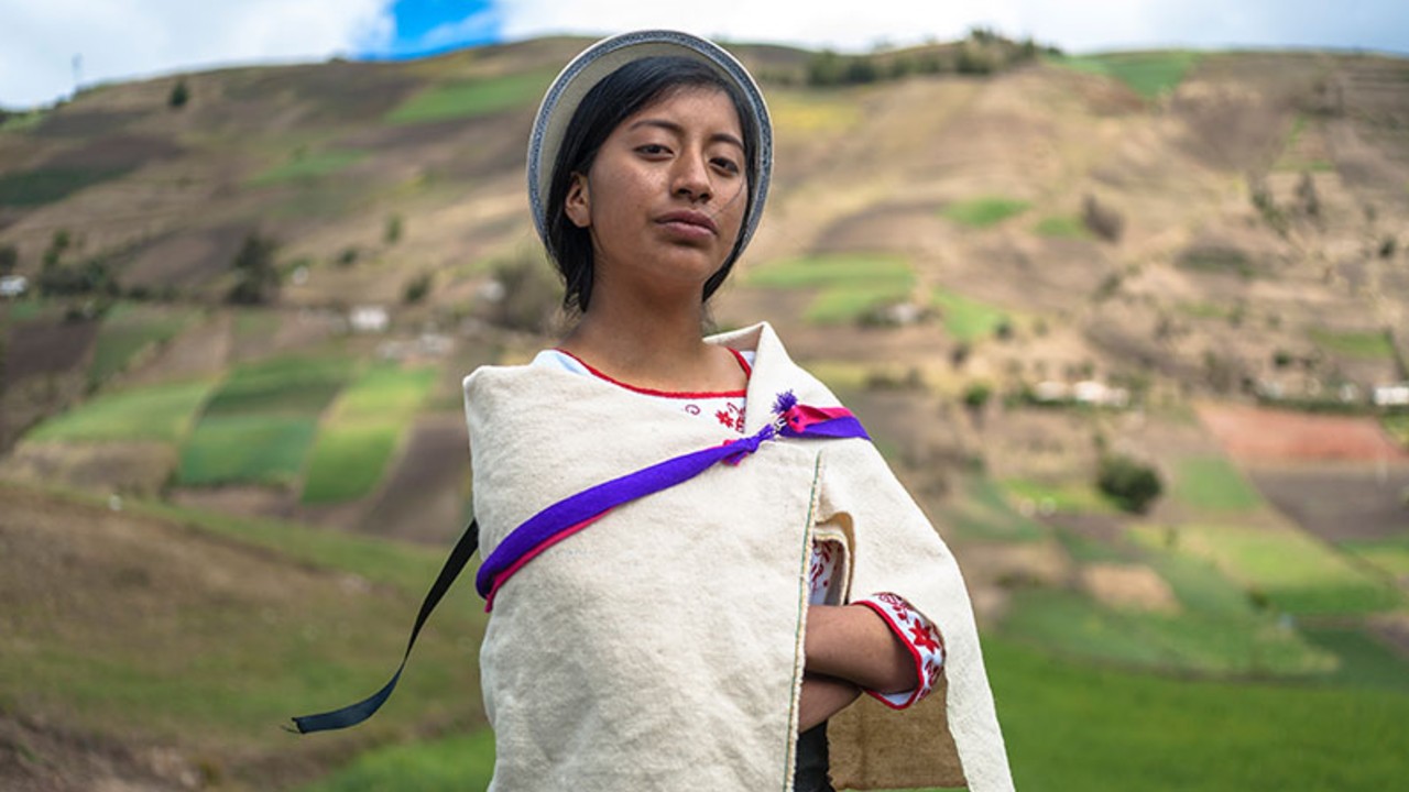 Peruvian young girl in a field looking proud and strong