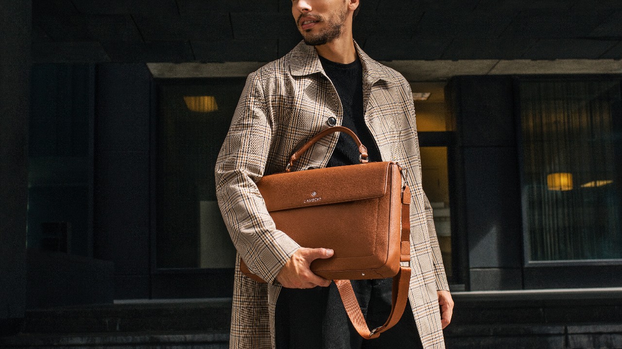 stylish man holding tan briefcase