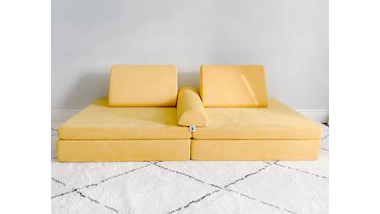Photo of a yellow play couch on a rug