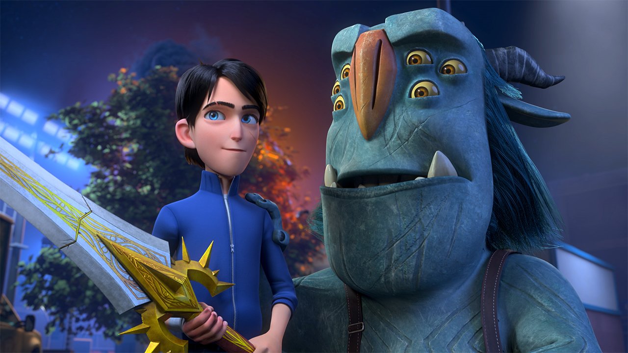 A computer-animated still from Trollhunters Rise of the Titan showing a human with a sword standing next to a monster with six eyes
